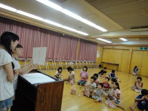 Students performing a picture-story show using Uzu folklore